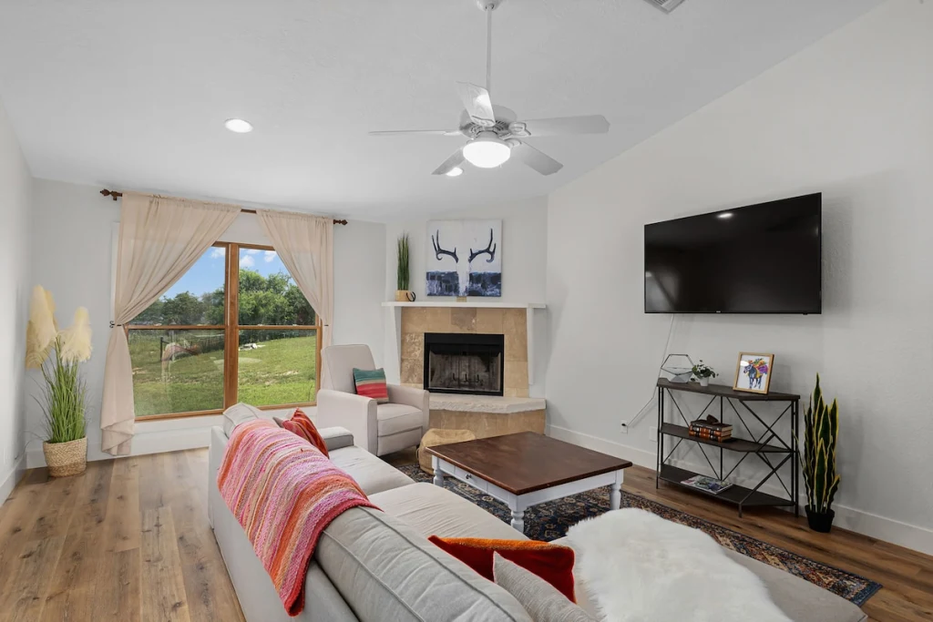 Barn House living area — bright white walls and vaulted ceiling