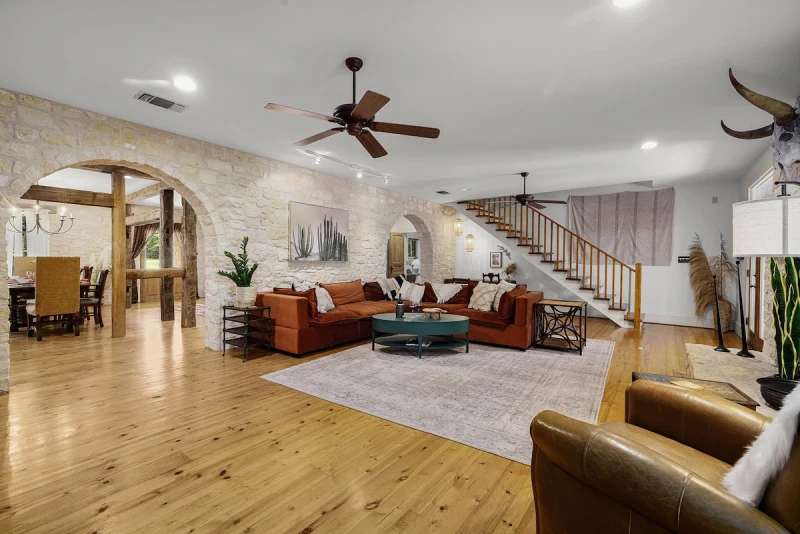 Main House living room — open plan with stone fireplace and comfortable seating