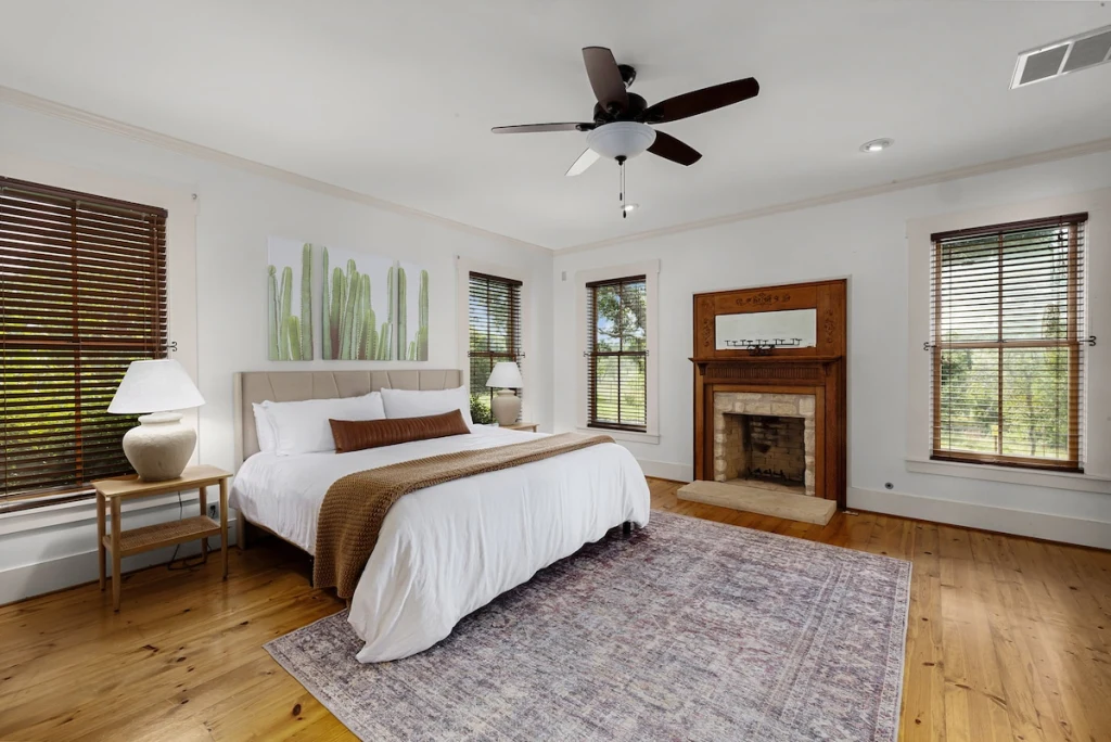 Main House primary bedroom — king bed with fireplace and ensuite