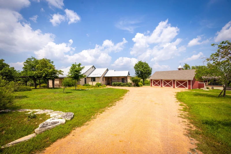 Long dirt driveway arrival toward the Main House