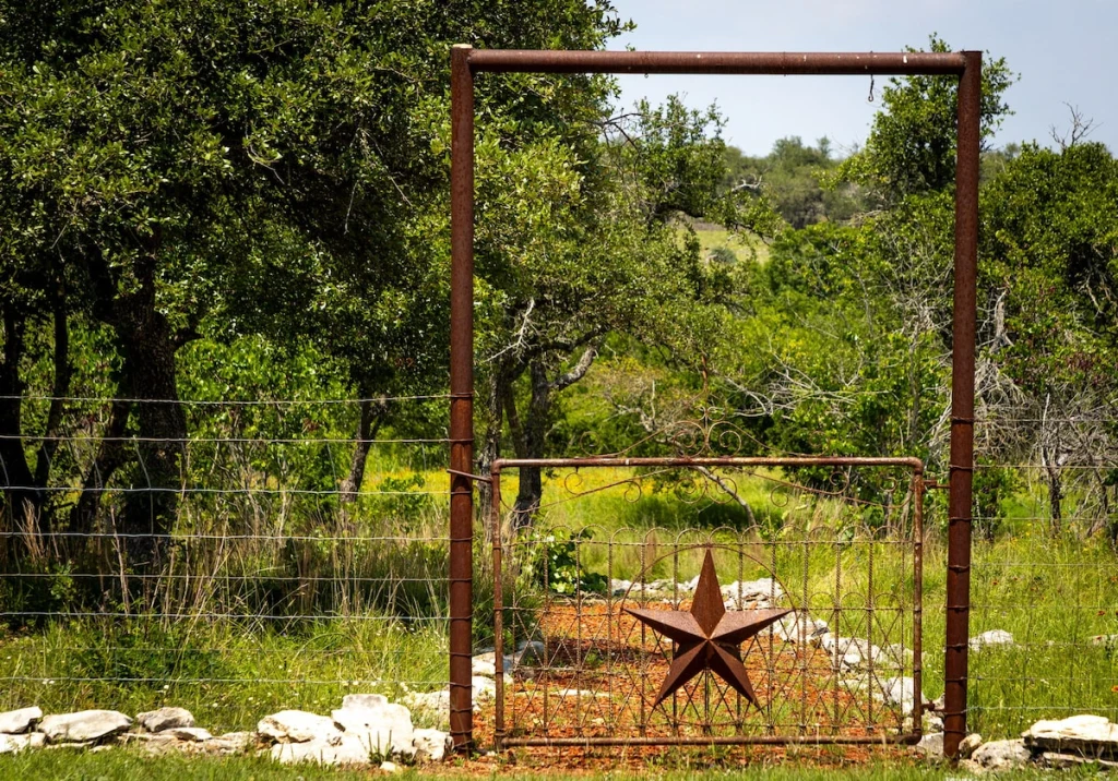 Rustic iron ranch gate with a Texas star along the walking trail